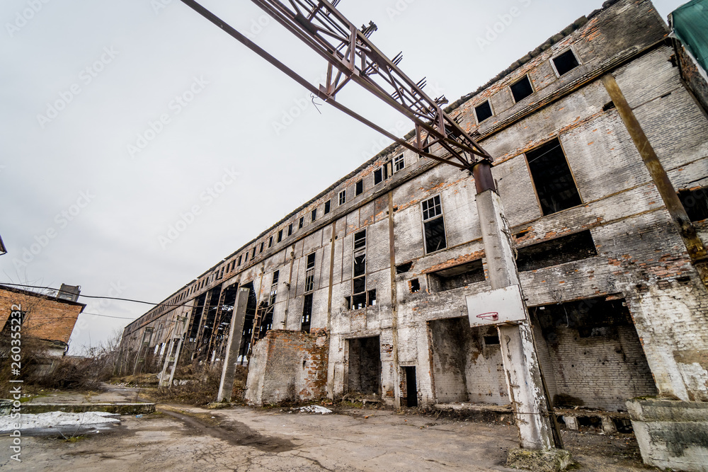 Derelict building with smashed windows, factory exterior. An old factory which lies abandoned in the industrial centre outside.