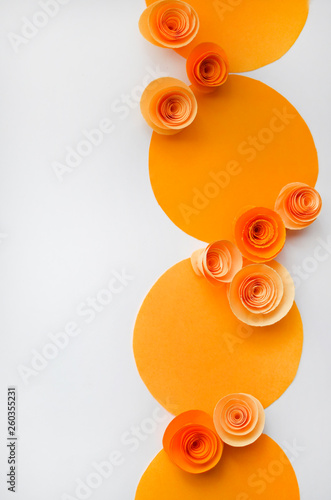 Colorful handmade paper flowers on light coloured background for invitation and wedding
