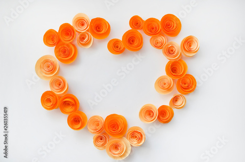 Colorful handmade paper flowers on light coloured background for invitation and wedding