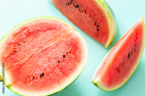 pieces of juicy watermelon on a pastel blue background
