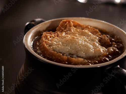 French onion soup topped with bread and cheese toasting in the oven