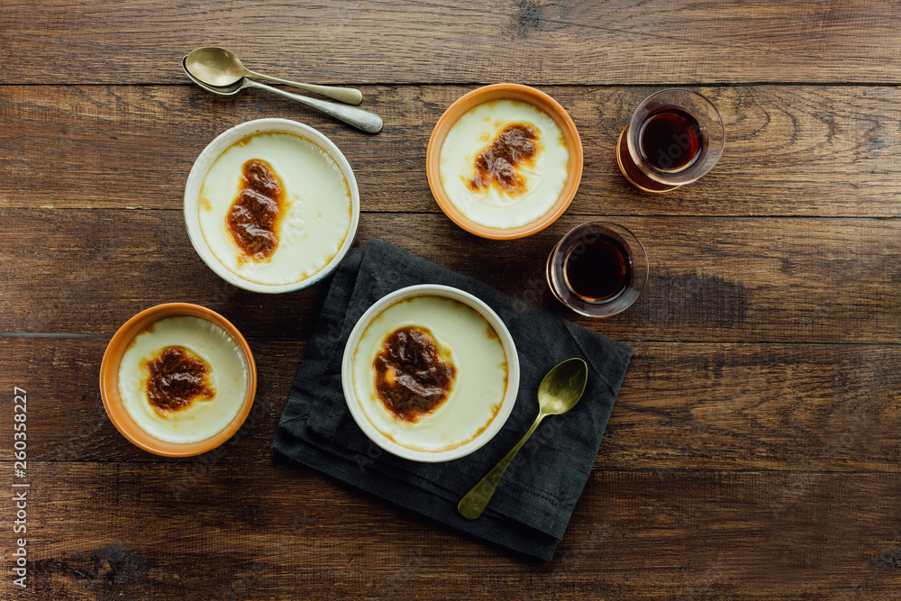 Turkish rice pudding on a wooden table, top view Turkish rice pudding on a wooden table, top view