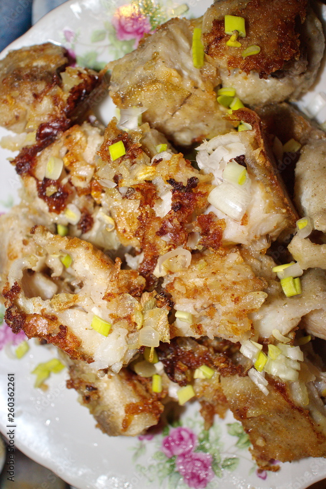 fried fish in a plate on the table