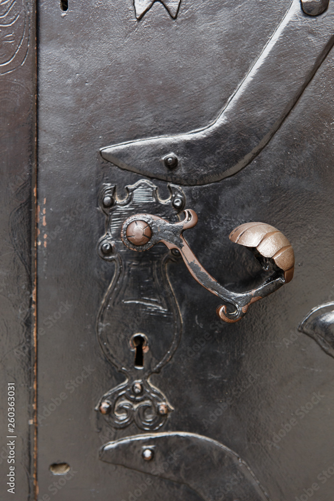 Old decorative door handle on metal door