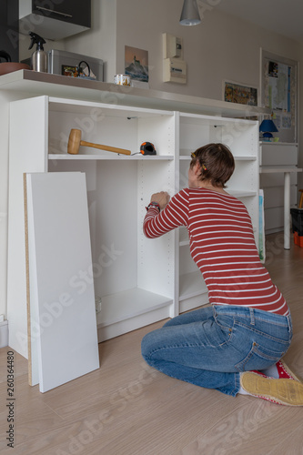 Paris, France - 03 23 2019: Woman doing DIY at home