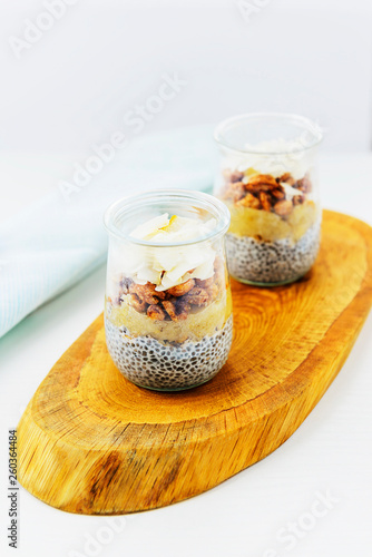 Chia pudding with coconut, banana and wheat in a glass. Healthy superfood for breakfast.