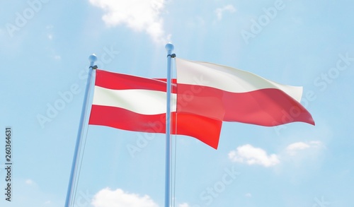 Austria and Poland, two flags waving against blue sky. 3d image