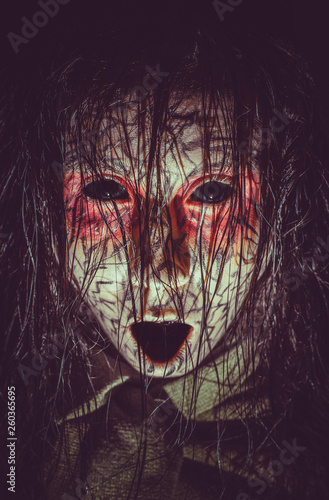 Infernal cursed girl with black eyes opened mouth and cracked skin close-up portrait