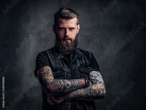 Valokuvatapetti Portrait of a stylish bearded guy with tattooed hands