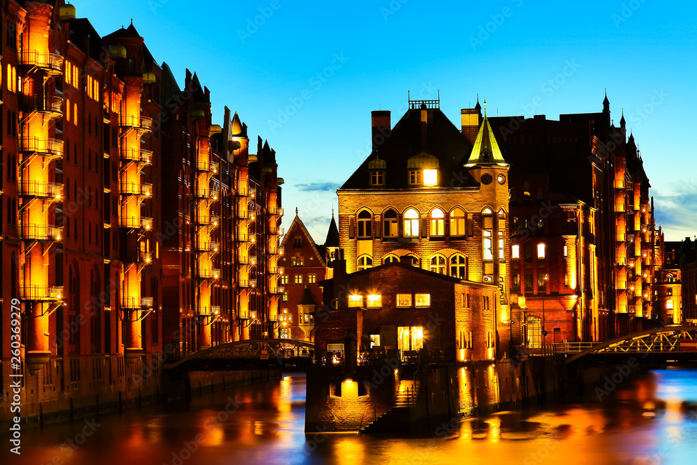 The Warehouse district Speicherstadt during twilight sunset in Hamburg, Germany. Illuminated warehouses in Hafencity quarter in Hamburg.