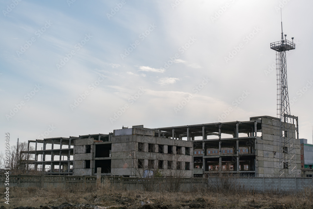 The frame of an unfinished abandoned building, in the open