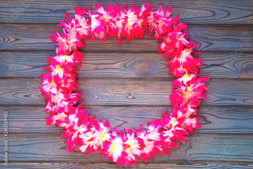 Hawaii wreath of flowers, on blue wooden background