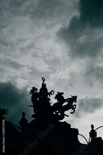 silhouette of a statue against a dark sky