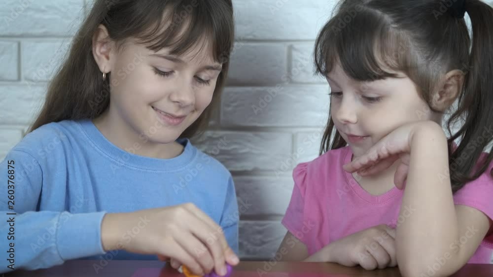 Kids with plasticine. Adorable little girls play with plasticine. Kids with plasticine. Adorable little girls play with plasticine.