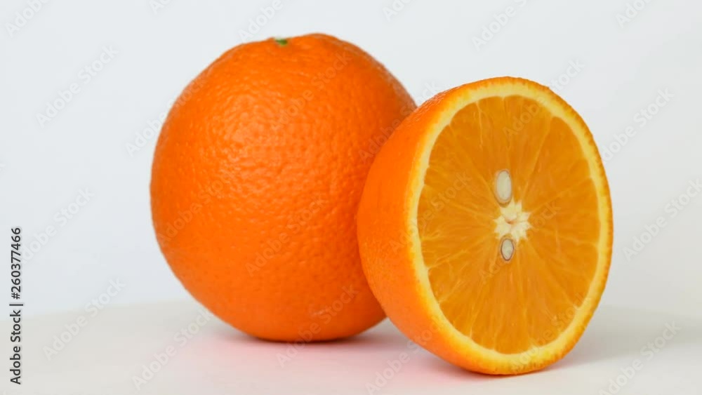 Whole and half orange rotating on white background Whole and half orange rotating on white background
