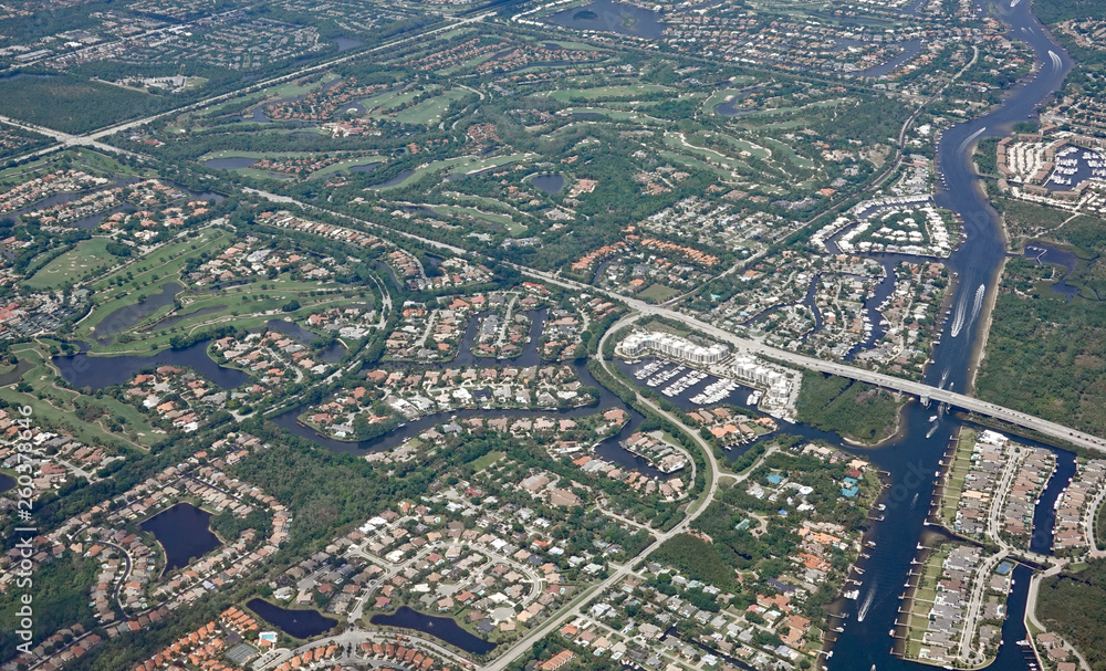 Aerial view of the Donald Ross Bridge in Juno Beach, Florida, and the surrounding gated golf communities.