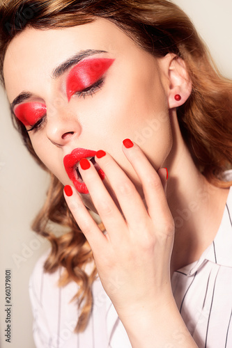 Beauty portrait of sexy women with glamour make up. Red lips and red eyeshadows, neils. Beauty fashion model face. Manicured hand with nails.  woman with luxury make-up, perfect manicure
