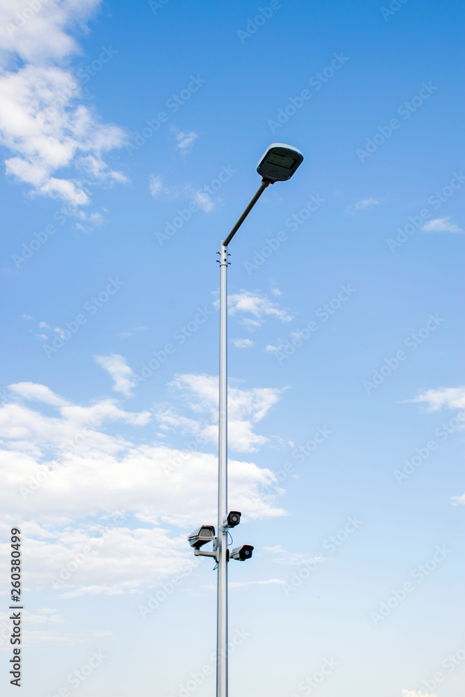 A camera installed on a streetlight watches traffic 