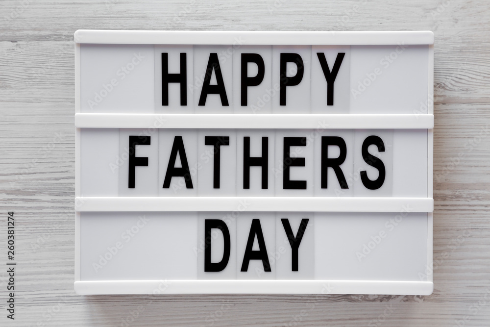 Lightbox with 'Happy Fathers Day' words over white wooden background, top view. Overhead, from above, flat lay. Close-up. Lightbox with 'Happy Fathers Day' words over white wooden background, top view. Overhead, from above, flat lay. Close-up.