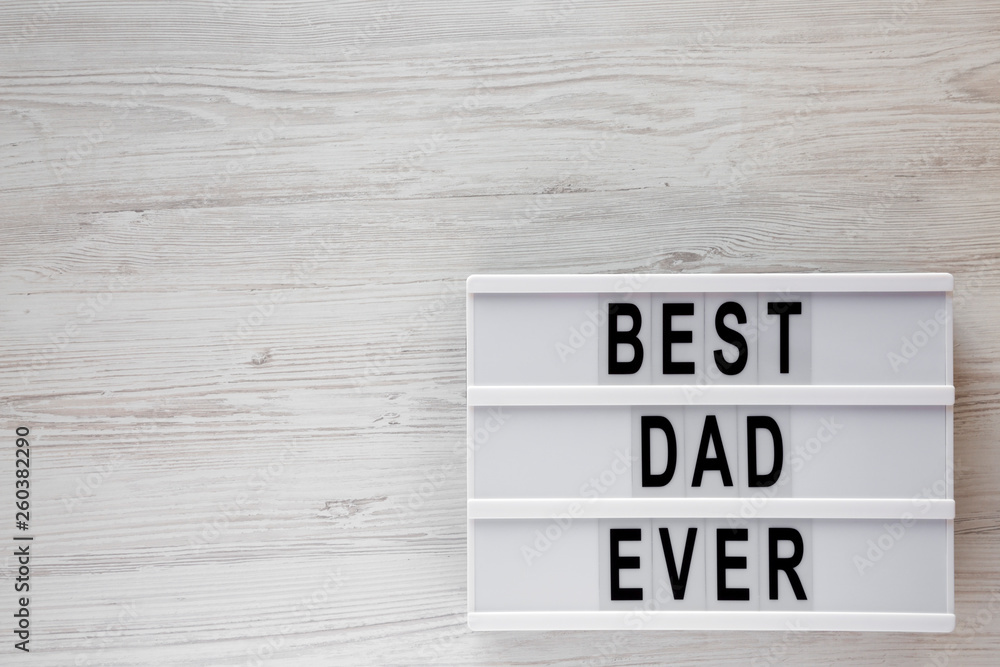 'Best dad ever' words on lightbox over white wooden surface, top view. Overhead, from above, flat lay. Copy space. 'Best dad ever' words on lightbox over white wooden surface, top view. Overhead, from above, flat lay. Copy space.
