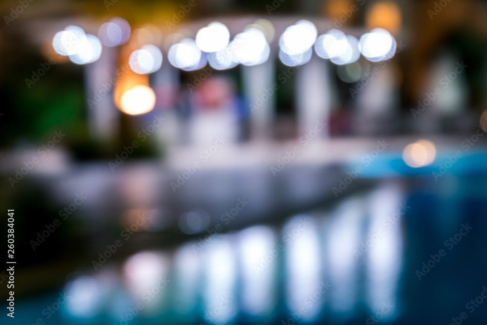 blurred night background, colored lights, water and buildings in defocus