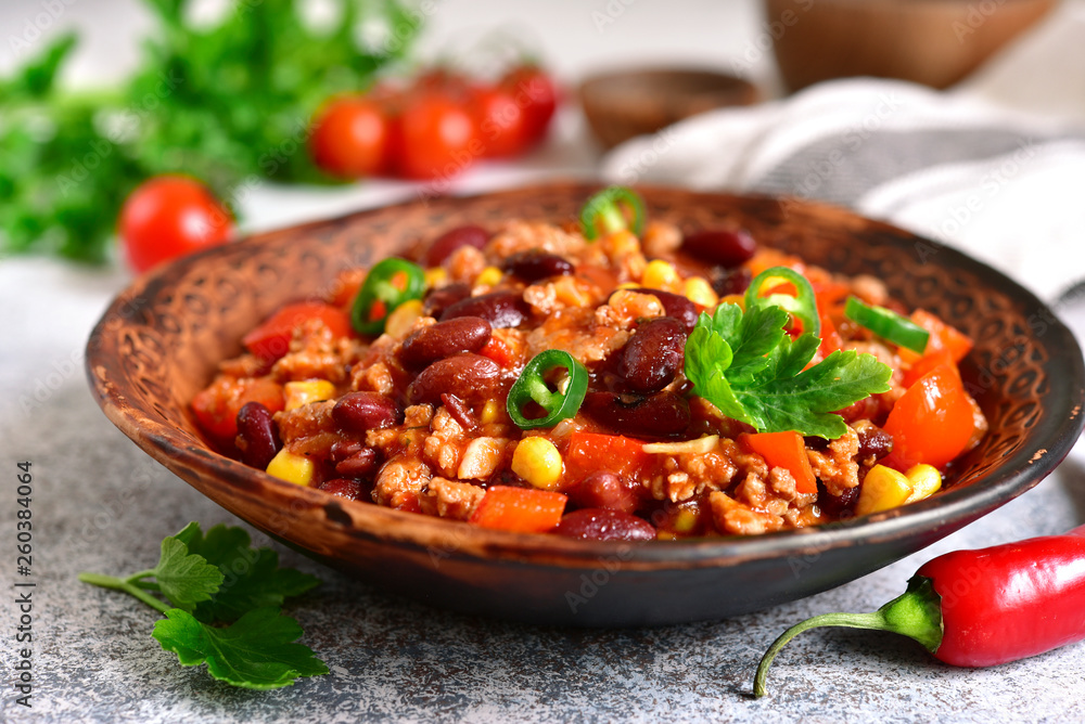 Chili con carne - minced meat stew with red bean and tomato.Traditional dish of mexican cuisine. Chili con carne - minced meat stew with red bean and tomato.Traditional dish of mexican cuisine.