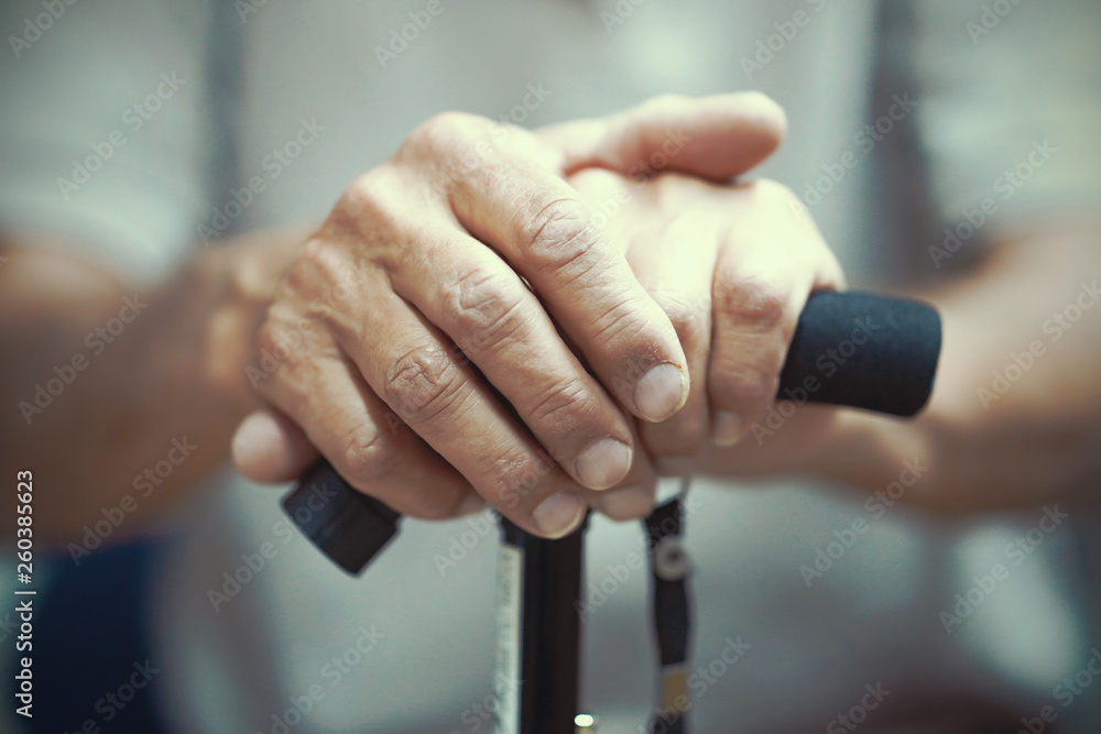 Senior Man Holding Cane. Close-up Of old man Hands On Walking Stick. Hand of a old man holding a cane. Toning.