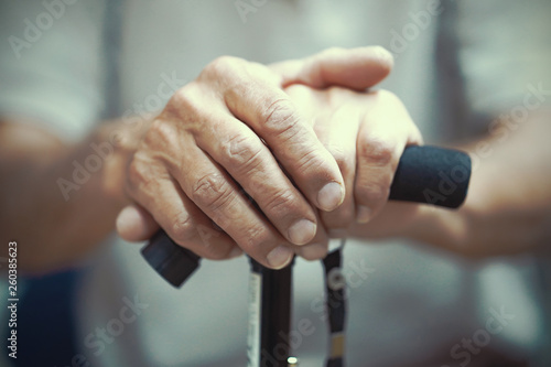 Senior Man Holding Cane. Close-up Of old man Hands On Walking Stick. Hand of a old man holding a cane. Toning.
