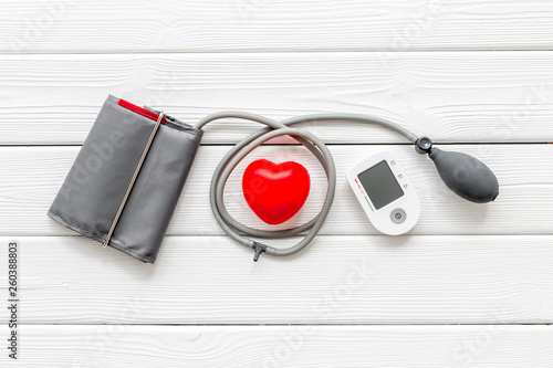 diagnostics of cardiac disease with pulsimeter on white wooden background top view photo