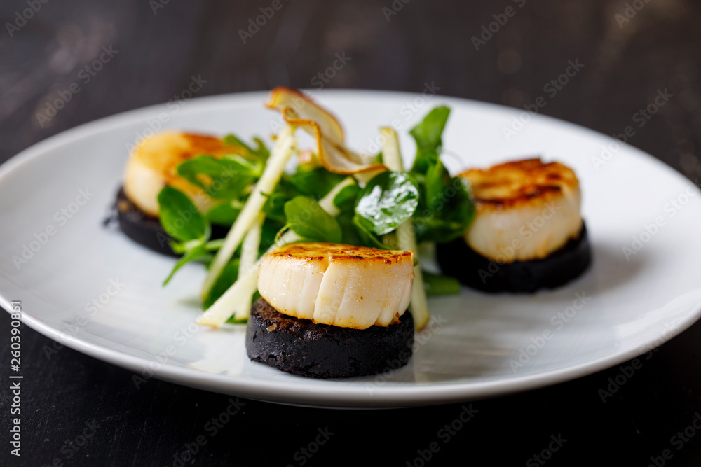 Scallops with black pudding and apple and pea shoots salad