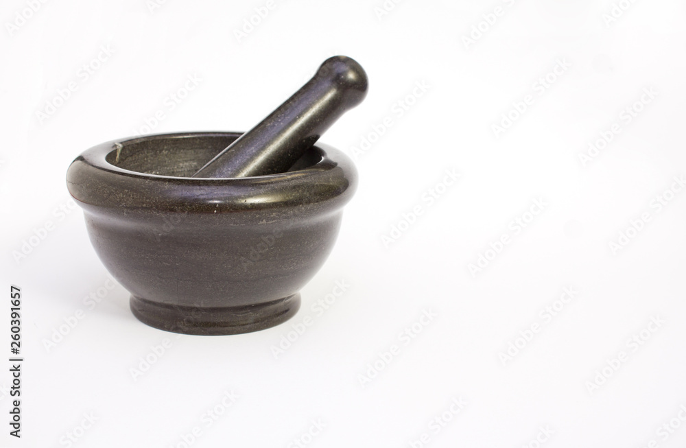 Black marble pestle and mortar on white background on left. Black marble pestle and mortar on white background on left.