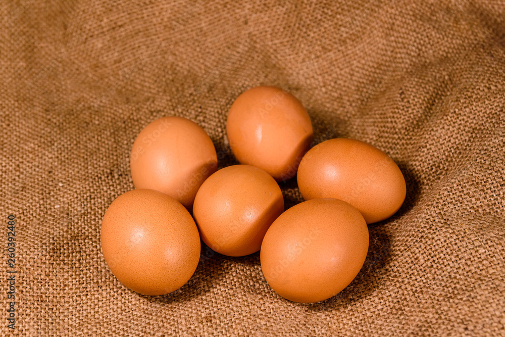 Pile of the hen eggs on sackcloth Pile of the hen eggs on sackcloth