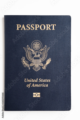 The iconic dark blue cover with gold stamp of an american passport deliberately and artistically set on a plain white background.