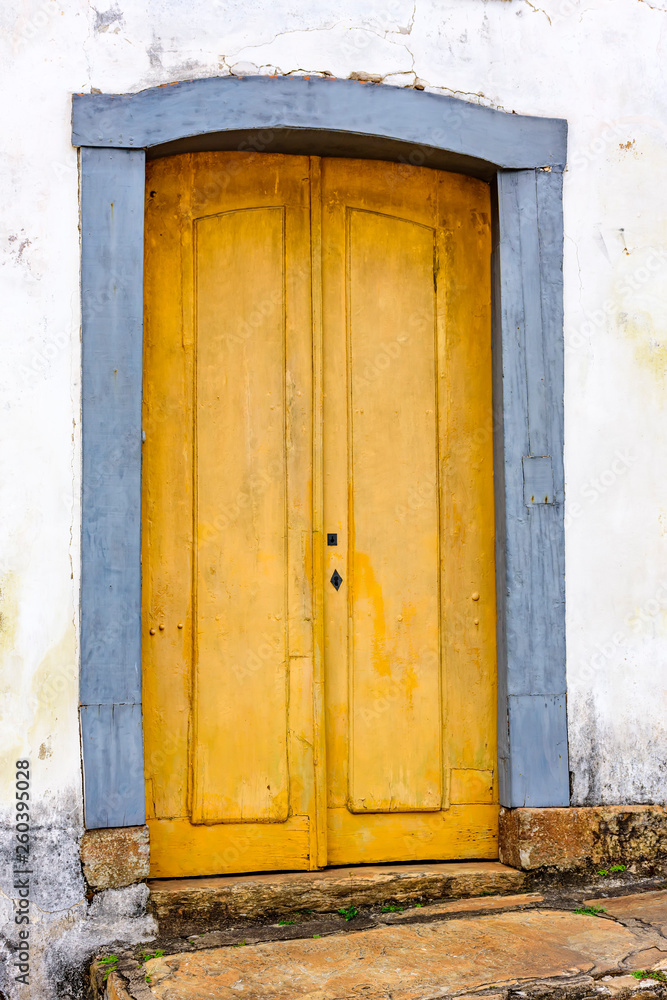 Old and aged historic church door from the Empire era in colonial wooden architecture in the city of Ouro Preto, Minas Gerais
