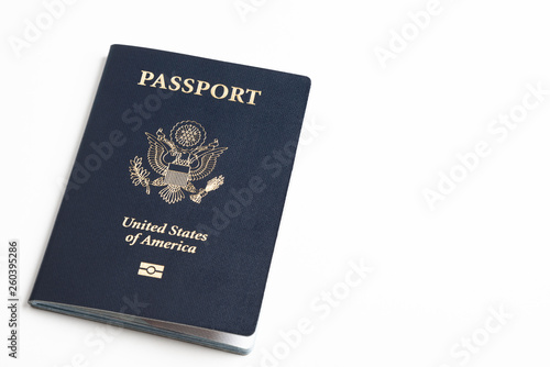 The iconic blue cover of an American passport deliberately and artistically set on a plain white background.