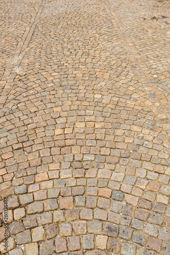 Wet cobblestone street in a swirl pattern for background or t