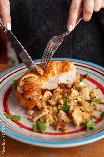 Lush croissant with chicken, soft cream cheese and scramble photo