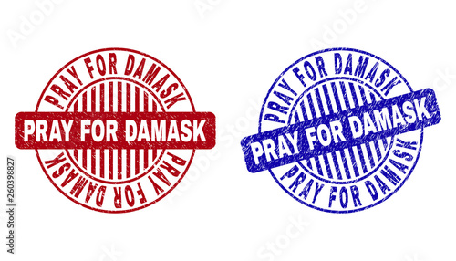 Grunge PRAY FOR DAMASK round stamps isolated on a white background. Round seals with grunge texture in red and blue colors.