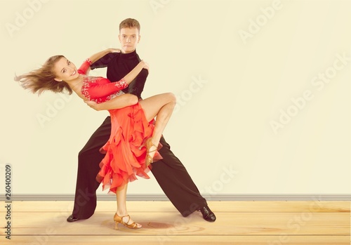 Man and a woman dancing Salsa on background