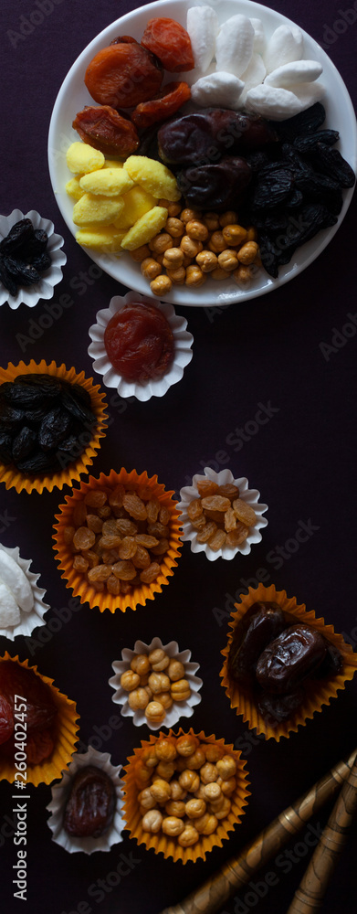 Fototapeta premium Eid Mubarak. Different iftar sweets. Celebrating Eid Al Adha. Islamic traditional holiday. Eid al-Fitr. Holly month Ramadan. Middle Eastern religious holiday. Dried date fruit. Flat lay, top view.