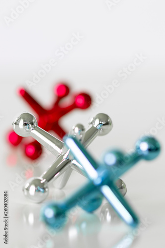 Toy jacks on white surface with selective focus and copy space