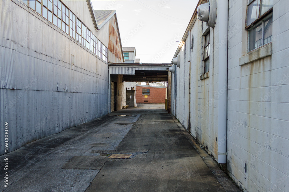Alleyway between to buildings of an abandoned factory