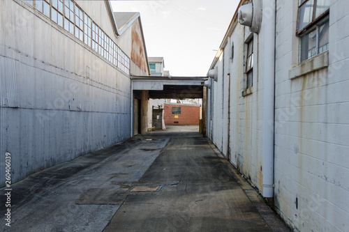 Alleyway between to buildings of an abandoned factory © Richard