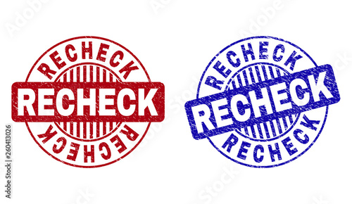 Grunge RECHECK round stamp seals isolated on a white background. Round seals with distress texture in red and blue colors. Vector rubber imprint of RECHECK label inside circle form with stripes. photo