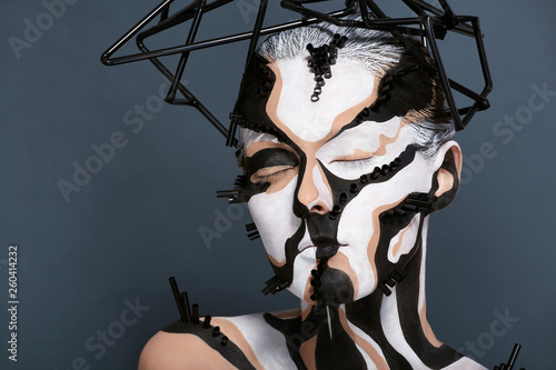 Female model with creative abstract makeup in futuristic hat