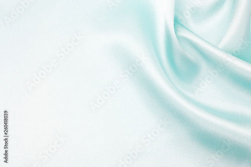 The texture of the satin fabric of blue color for the background