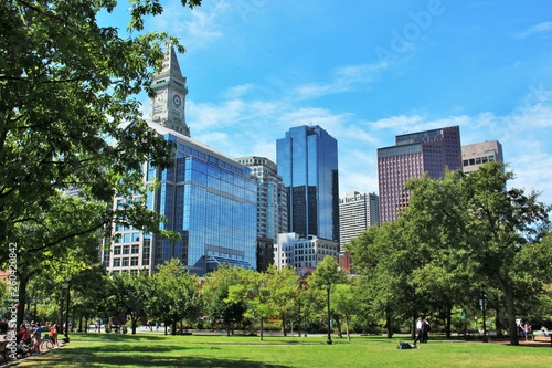 Christopher Columbus Park in Boston, MA on a sunny summer day with Boston skyline and clock tower in the background