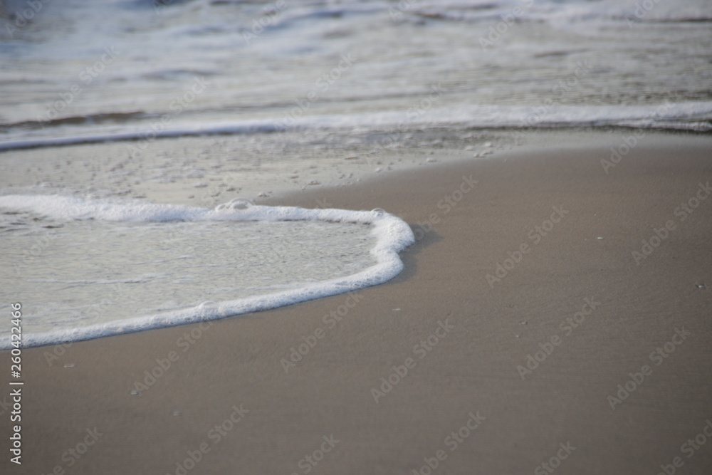 Bubble Foam of the Sea Wave on the Beach and Fine Sand, Summer Holidays Bubble Foam of the Sea Wave on the Beach and Fine Sand, Summer Holidays