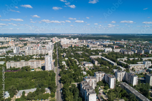 Top down aerial drone image of a Ekaterinburg city in the midst of summer, backyard turf grass and trees lush green.