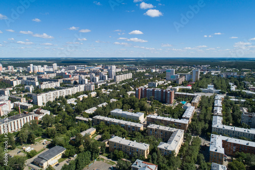 Top down aerial drone image of a Ekaterinburg city in the midst of summer, backyard turf grass and trees lush green. © flyural66